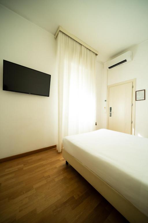 Postel nebo postele na pokoji v ubytování Hotel Rosabianca