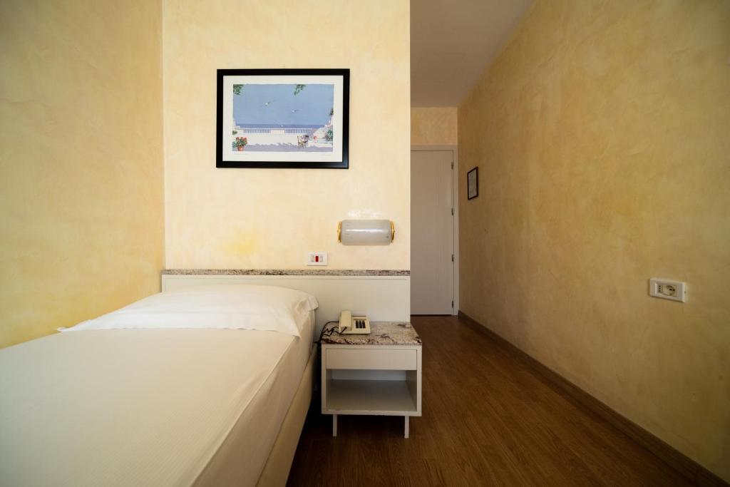 Postel nebo postele na pokoji v ubytování Hotel Rosabianca