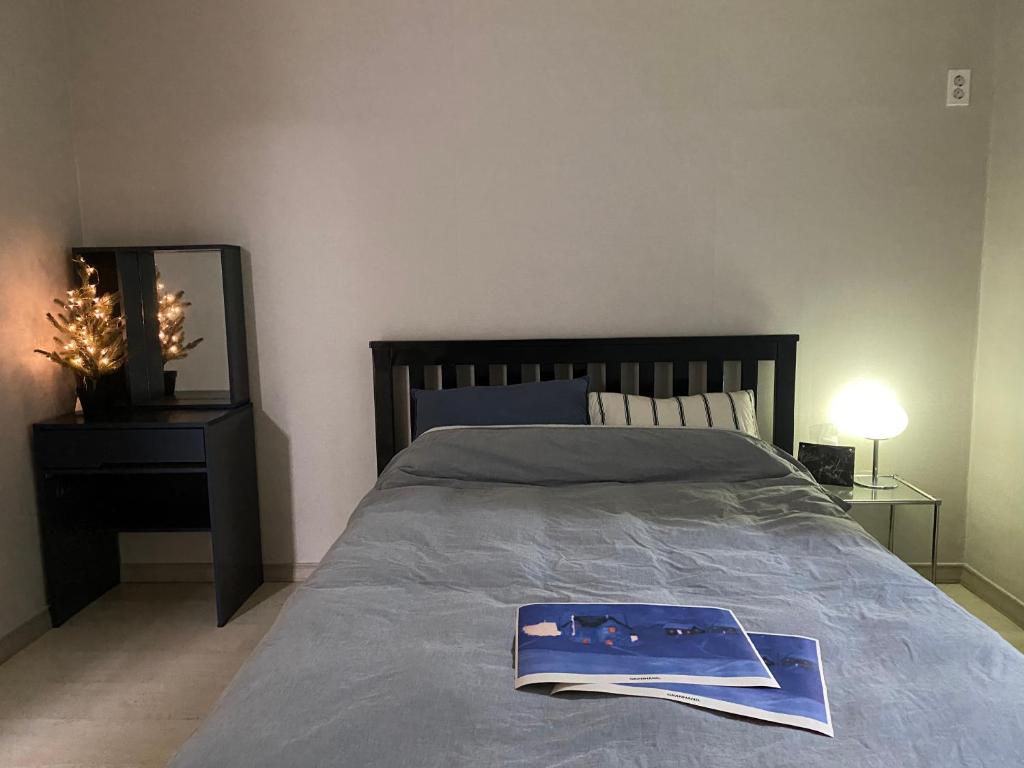 a bedroom with a bed with a book on it at 스테이 휴가 의정부점 in Uijeongbu