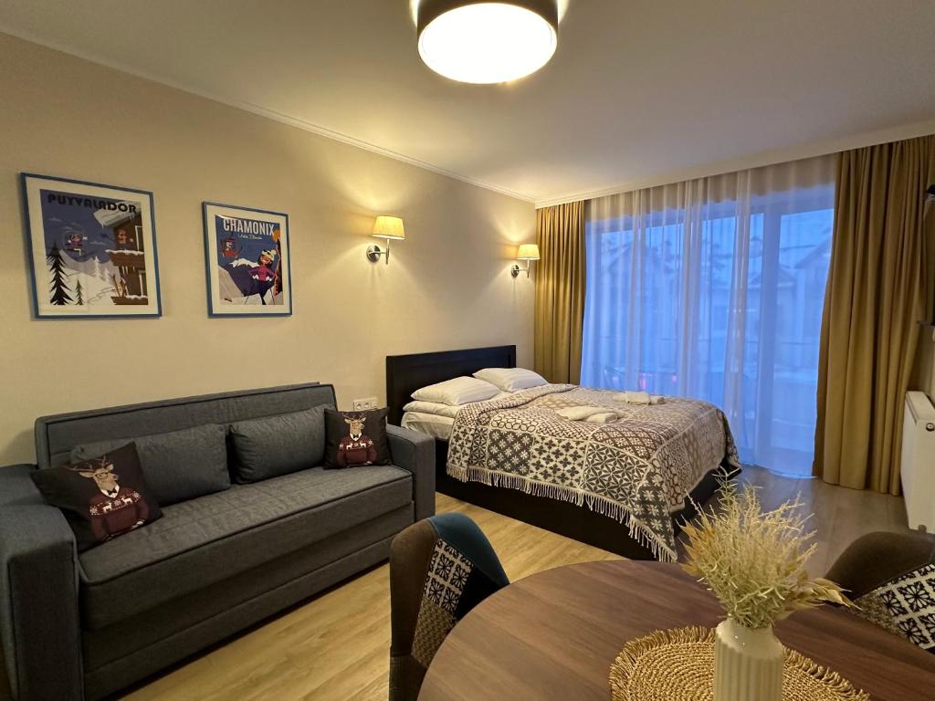 Postel nebo postele na pokoji v ubytování New Gudauri Alpen Apartments