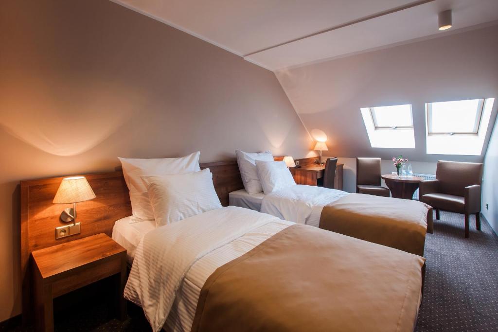 Postel nebo postele na pokoji v ubytování Hotel Gem
