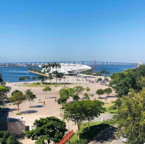 a park near the ocean with a bridge in the background at Suíte 204 - Pousada no Centro do Rio in Rio de Janeiro