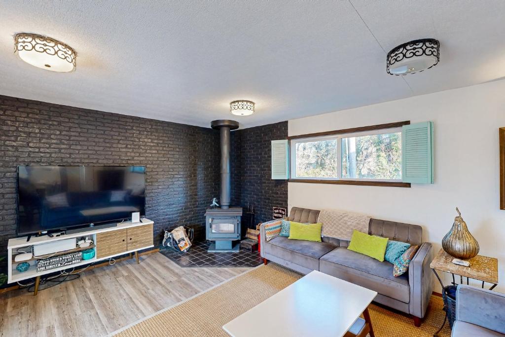 a living room with a couch and a flat screen tv at Rockaway Beach Villa in Rockaway Beach