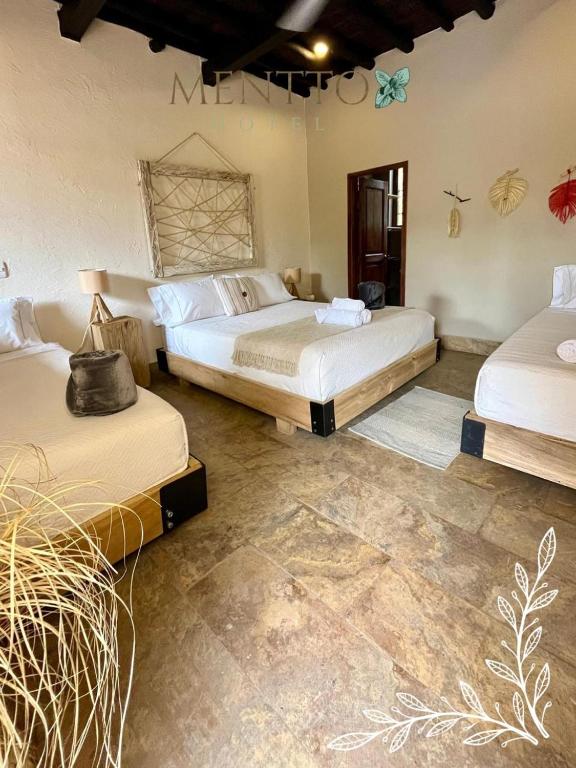 Postel nebo postele na pokoji v ubytování Mentto Hotel