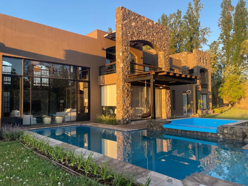 an exterior view of a house with a swimming pool at Casa Prana in Ciudad Lujan de Cuyo