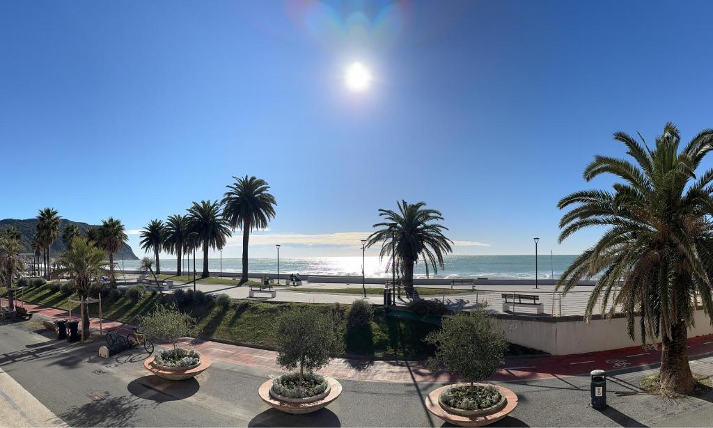 a view of a beach with palm trees and the ocean at Your Sea Escape in Riva Trigoso