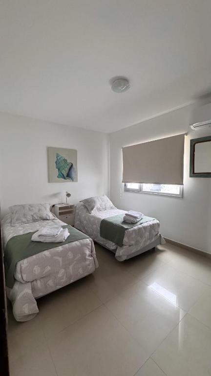 En eller flere senge i et værelse på Departamento Atlantic