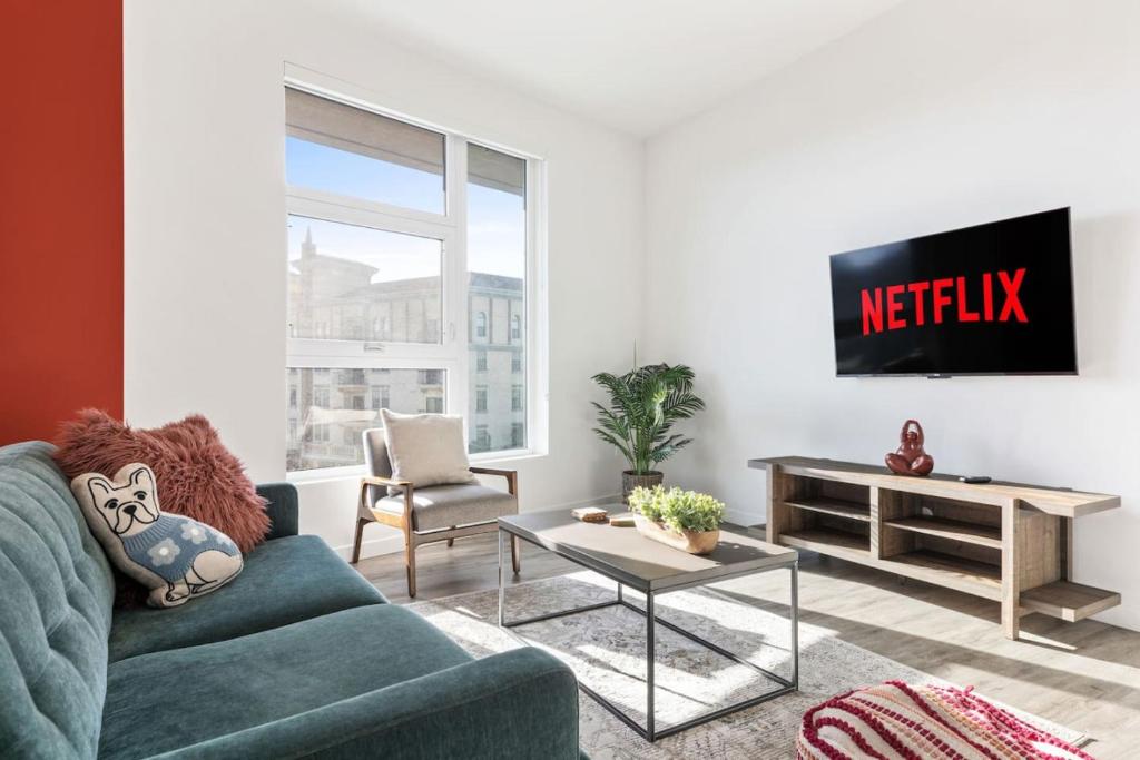 a living room with a couch and a tv at 2BD Modern DTLA Apartment Minutes from Dodger Stadium in Los Angeles