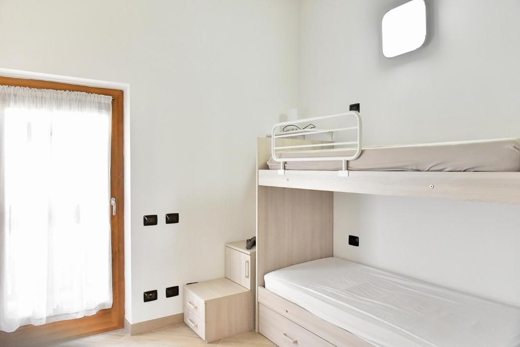 Łóżko lub łóżka w pokoju w obiekcie La Pieve Apartments