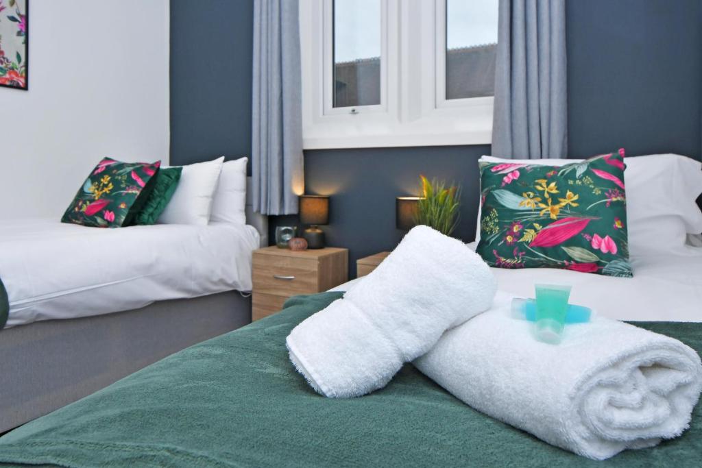 a room with two beds with towels on the bed at Stay @ The Old Bank Apartments, Burton on Trent in Burton upon Trent