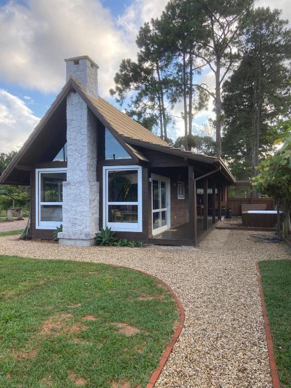 a small house with a gambrel roof at Cabana Encantada in Garopaba