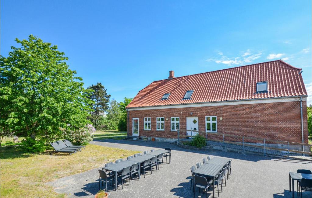 a brick building with benches in front of it at Eight-Bedroom Holiday Home In Glesborg in Glesborg