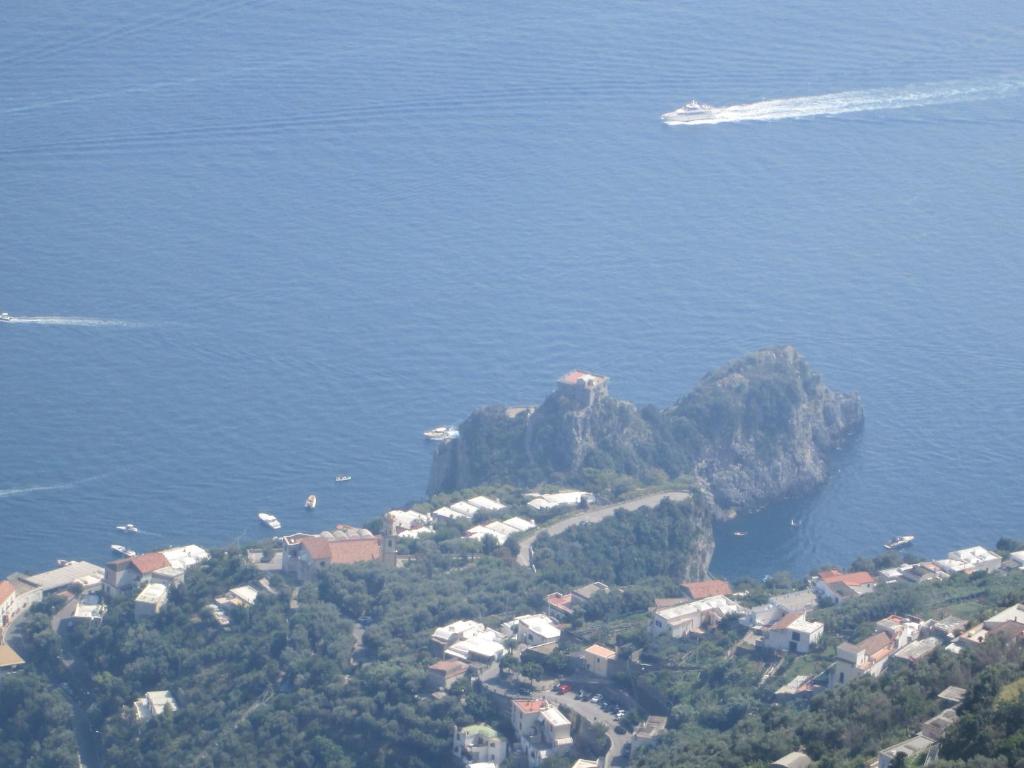 an island in the middle of the water with a boat at Luna D'Agerola in Agerola