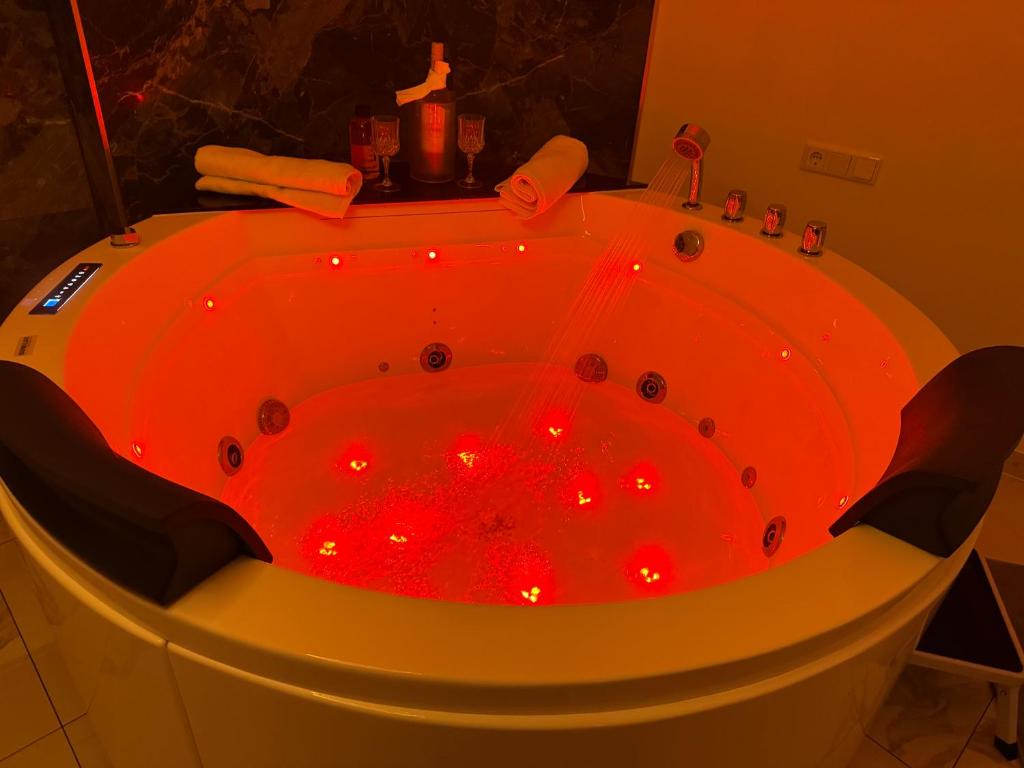 a red tub with red lights in a bathroom at Whirlpool-Zimmer-VIP in Diez