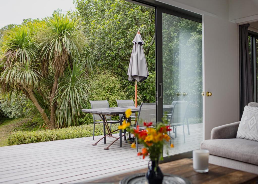 a patio with a table and an umbrella at Kia Noho in Havelock North