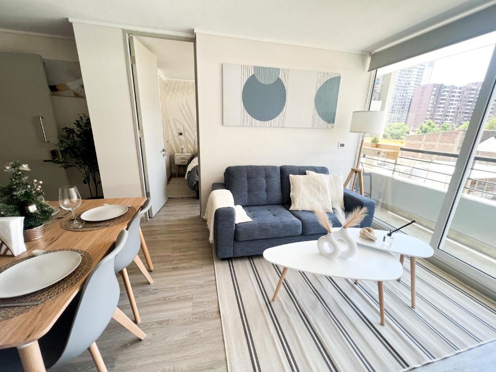 a living room with a couch and a table at exclusive apartment with AC and parking in Santiago