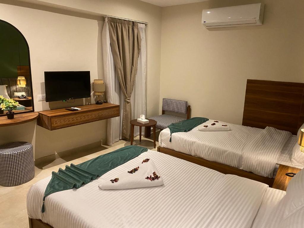 Postel nebo postele na pokoji v ubytování The Nomad Pyramids Boutique Hotel