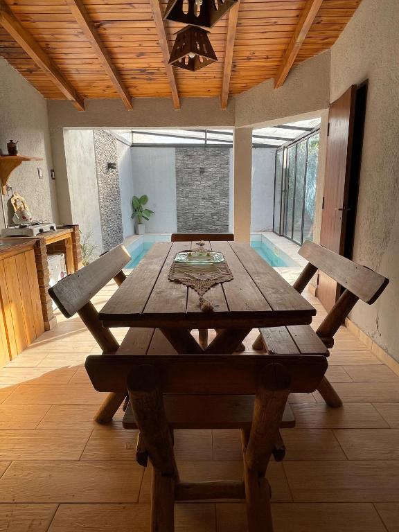 a dining room with a wooden table and chairs at Cassara Retreat in La Consulta
