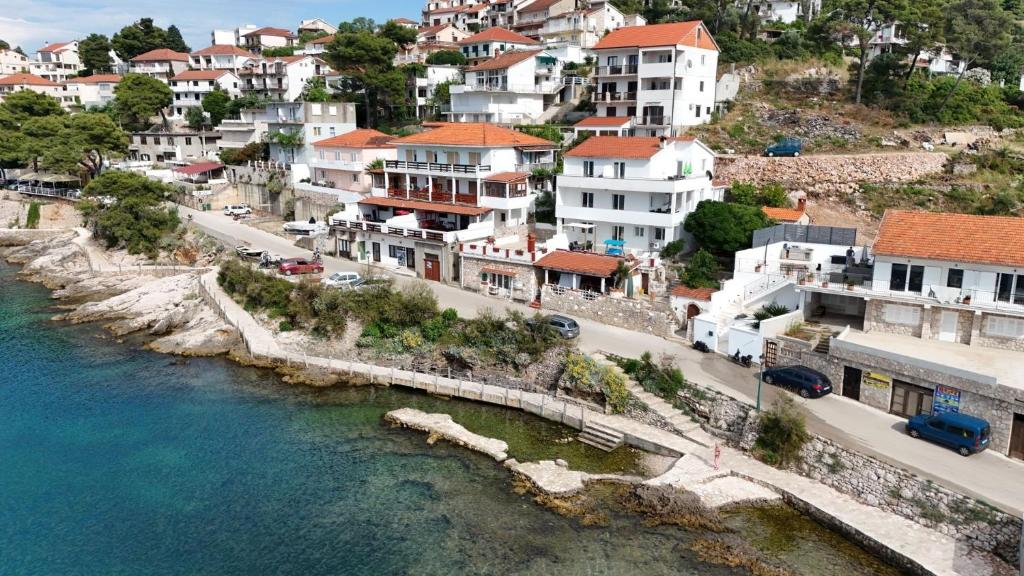 an aerial view of a town next to the water at Apartments by the sea Jelsa, Hvar - 22256 in Jelsa