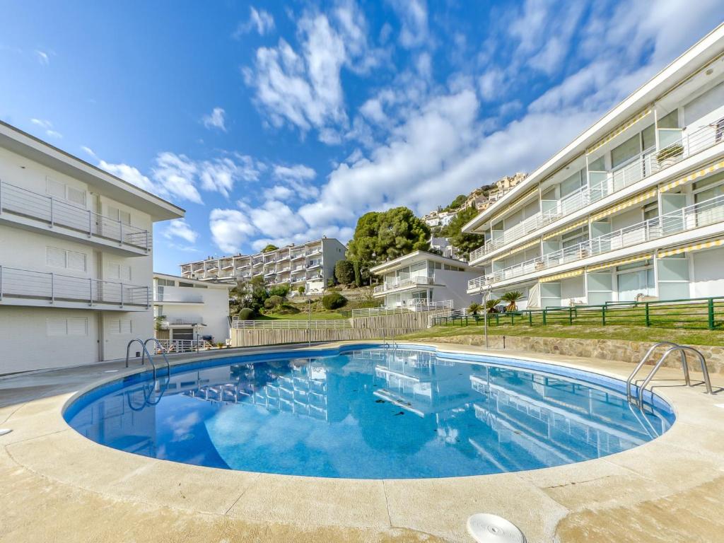 a large swimming pool in front of a building at Apartment in Roses near beach in Montjoys