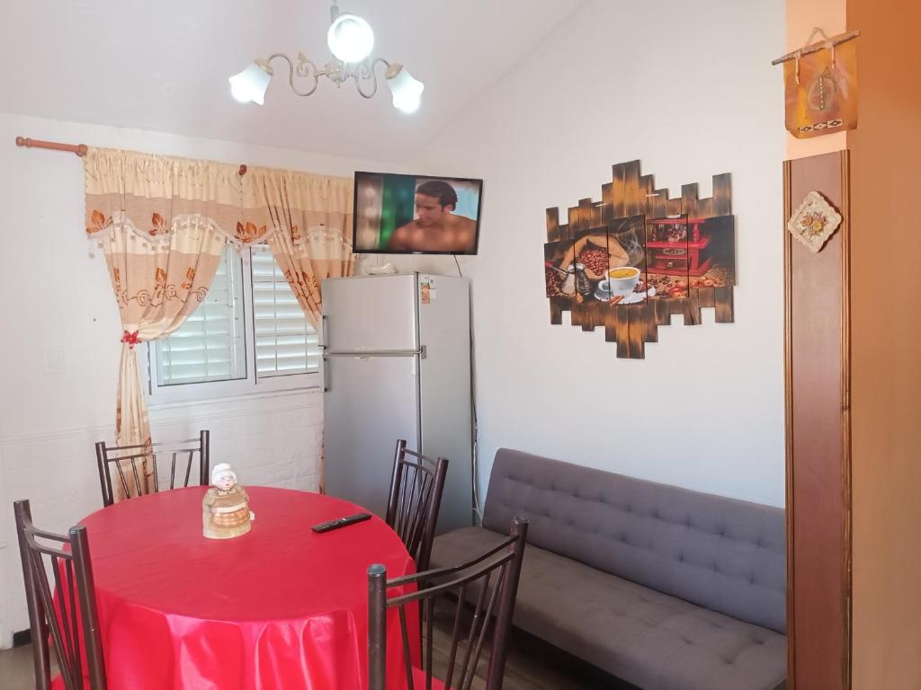 a dining room with a table and a refrigerator at La Juana in Juana Koslay 