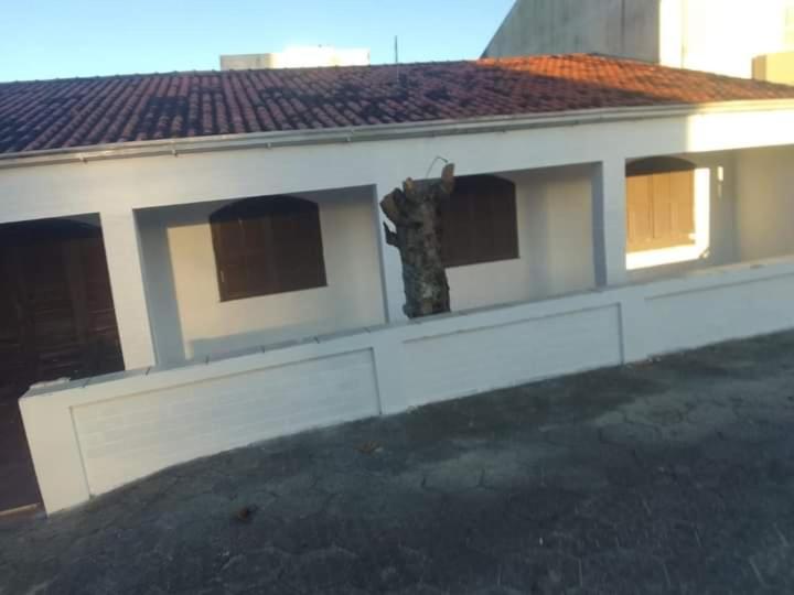 a building with a large window on the side of it at Casa de Praia aconchego in Guaratuba