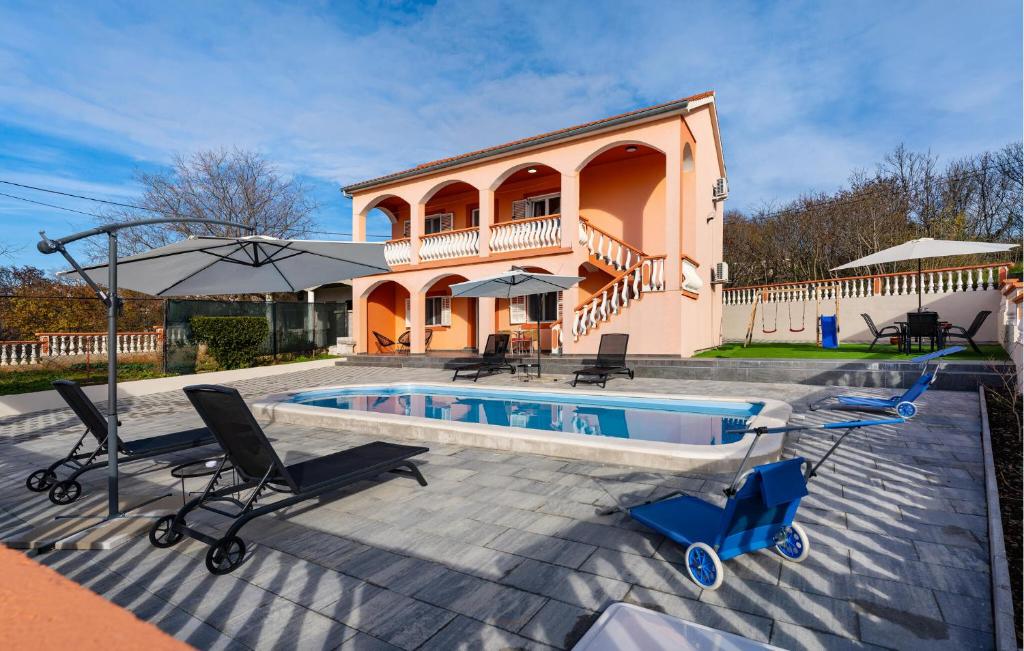 a house with a pool and chairs and an umbrella at Cdi941 in Slivnica