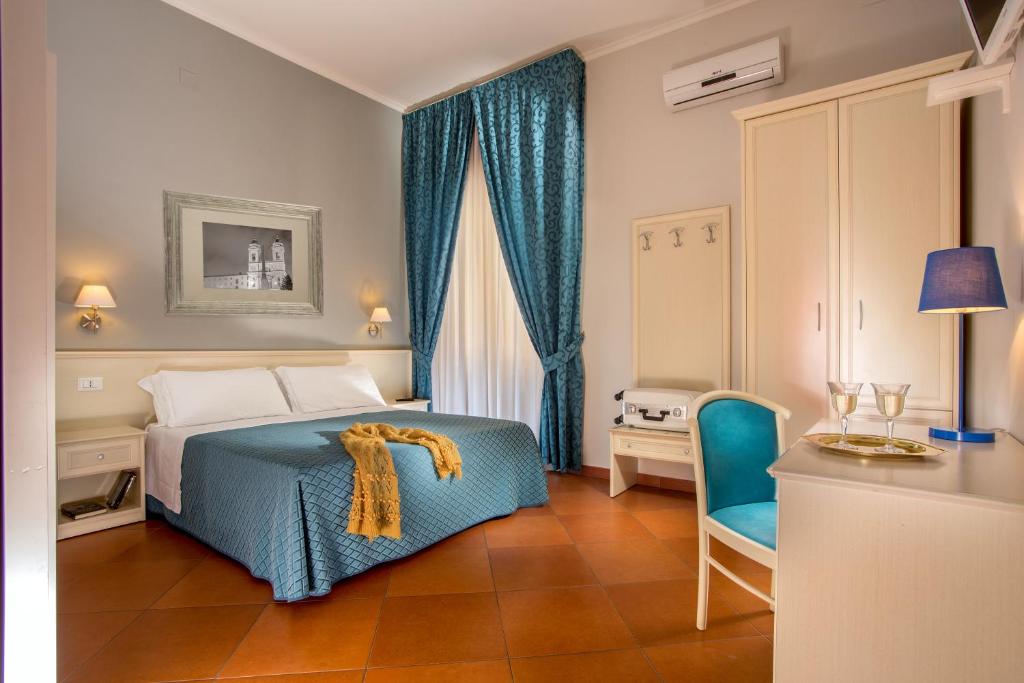 a bedroom with a bed and a table and a chair at Ottaviano Guest House in Rome