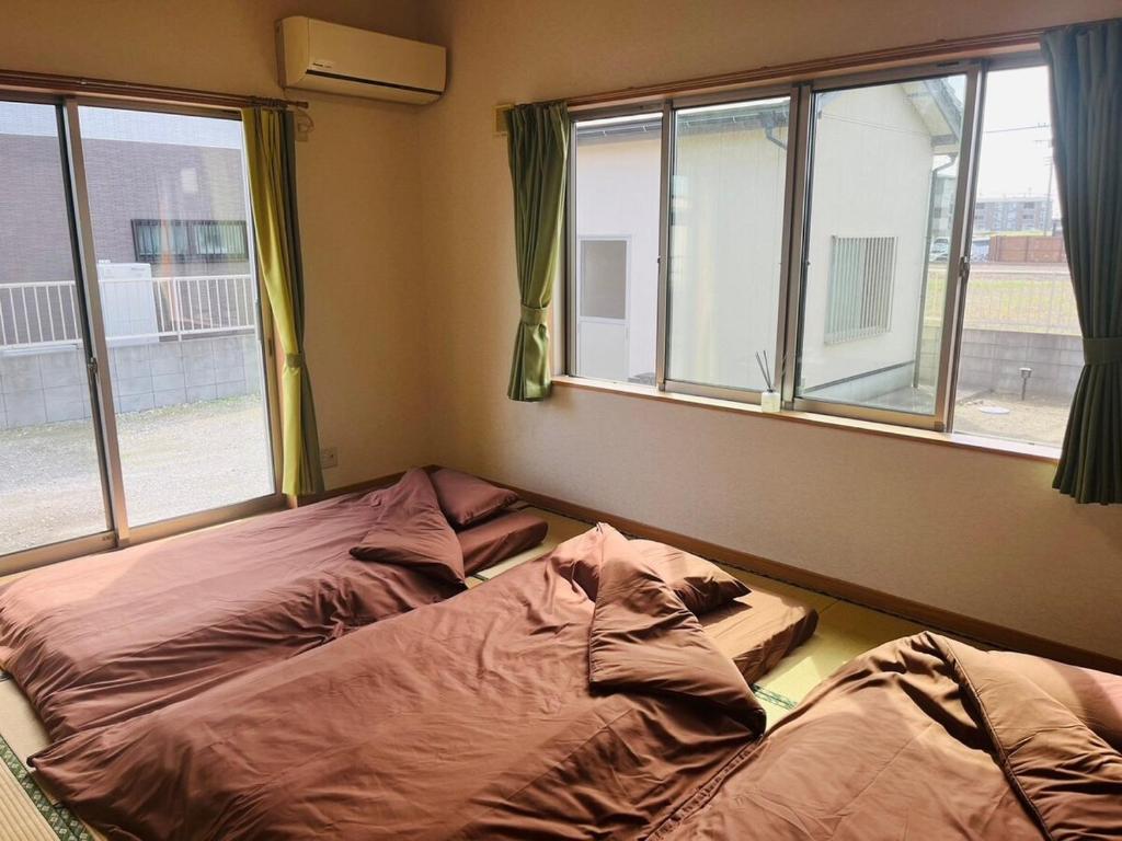 Postel nebo postele na pokoji v ubytování Nest Kisarazu