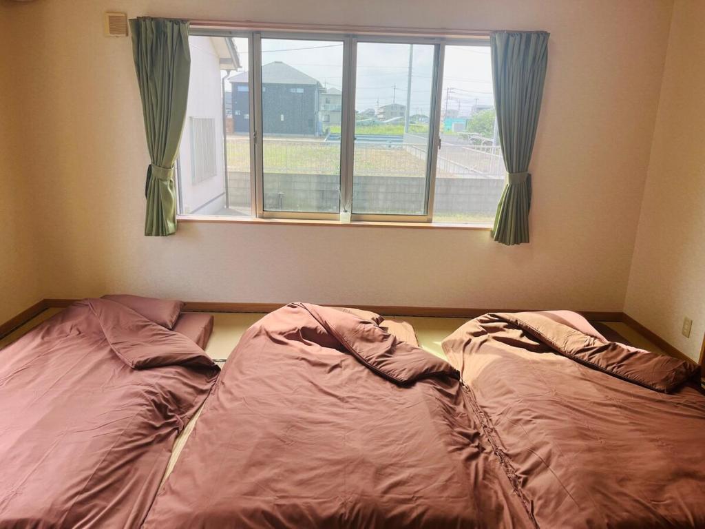 Postel nebo postele na pokoji v ubytování Nest Kisarazu