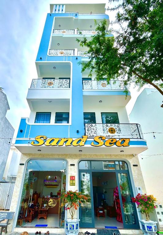 a building with a santoku soup sign on it at Sand Sea Hotel Phan Thiết in Phan Thiet