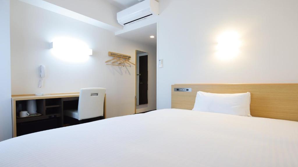 Postel nebo postele na pokoji v ubytování AB Hotel Kani
