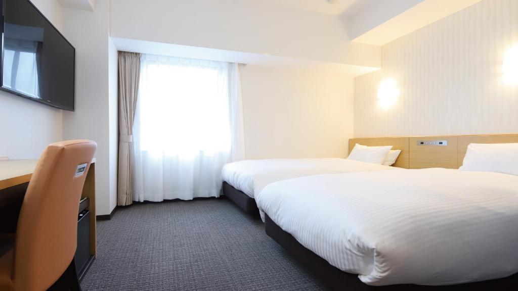 Postel nebo postele na pokoji v ubytování AB Hotel Kani
