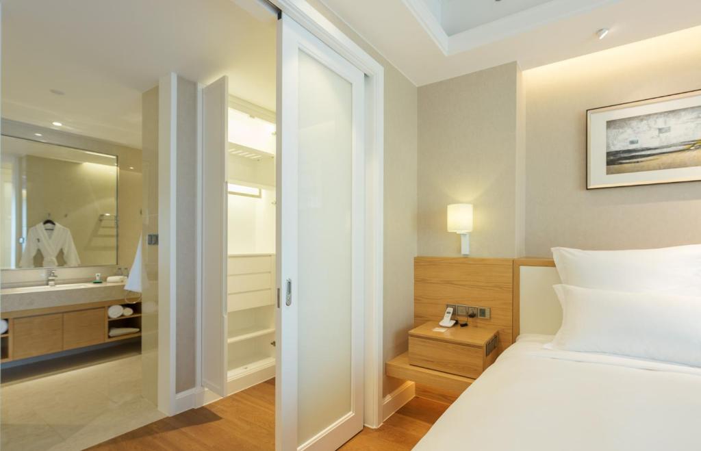 Postel nebo postele na pokoji v ubytování Residence G Nanshan