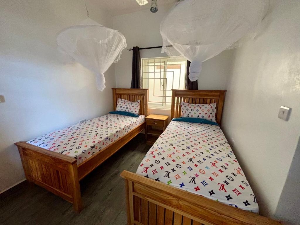 Postel nebo postele na pokoji v ubytování ZMK Hotel