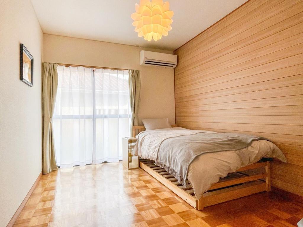 Postel nebo postele na pokoji v ubytování Sakuradai House