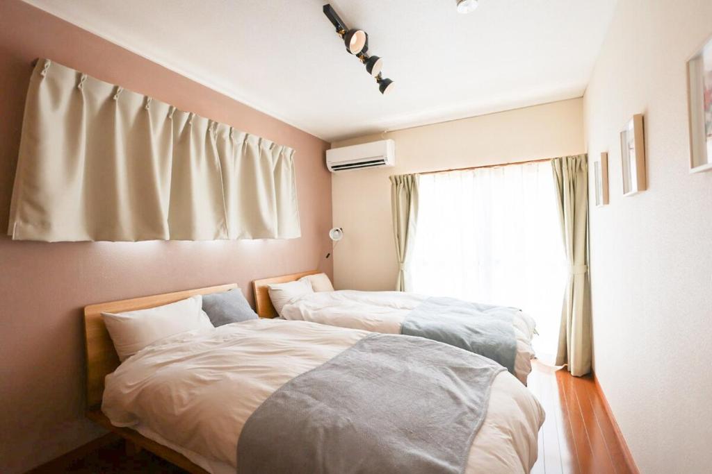 Postel nebo postele na pokoji v ubytování Sakuradai House