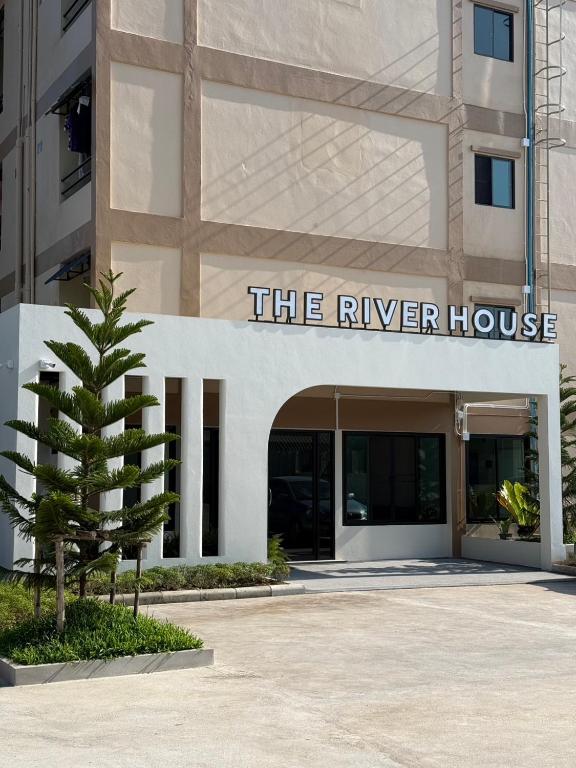 a building with a sign that reads the river house at theriverhouse in Ban Muang Nga