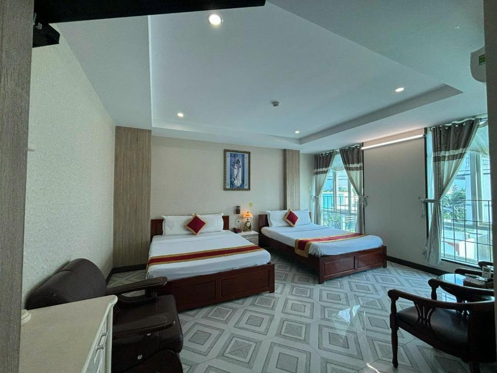 Postel nebo postele na pokoji v ubytování Thành Đạt Hotel Bạc Liêu
