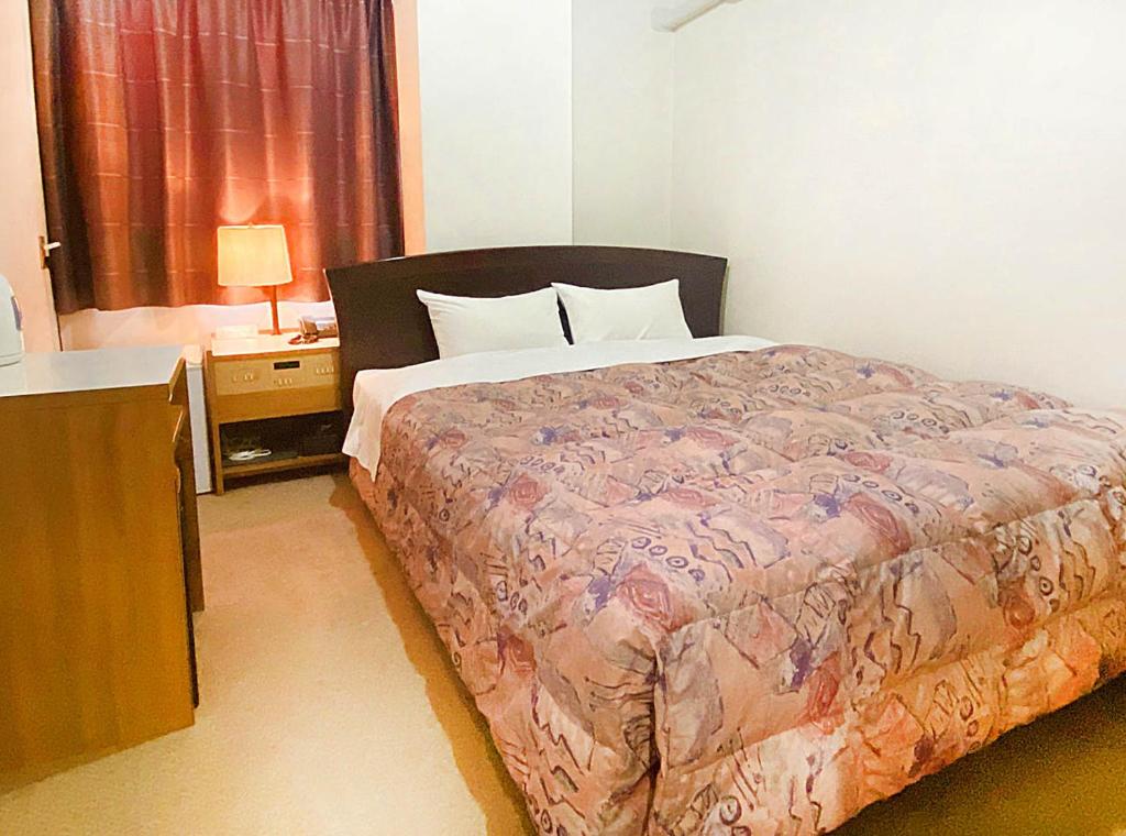 Postel nebo postele na pokoji v ubytování Hotel Okuni (Royal Inn Group)