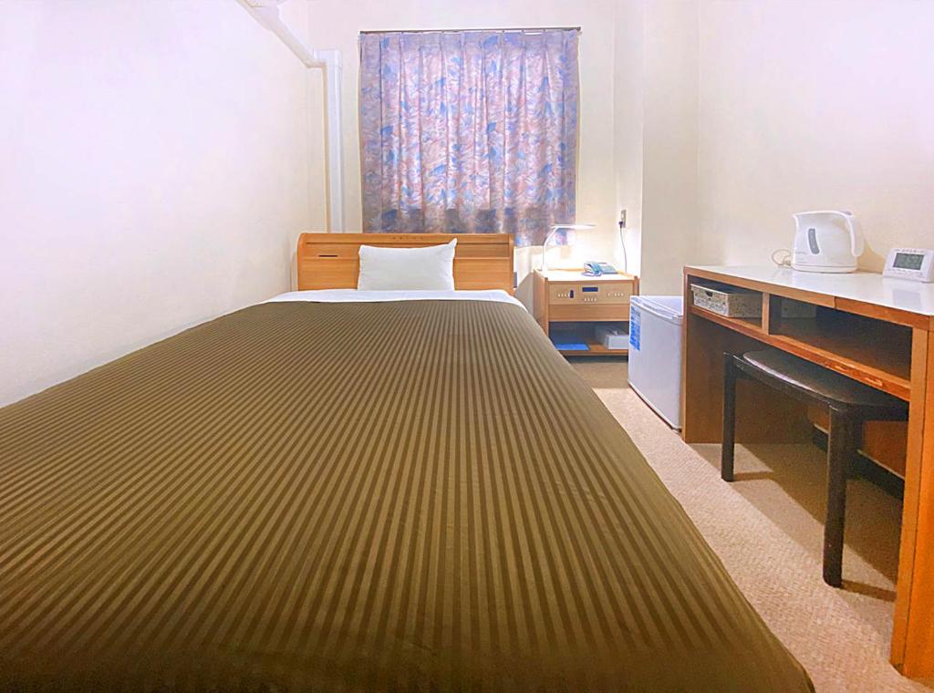 Postel nebo postele na pokoji v ubytování Hotel Okuni (Royal Inn Group)