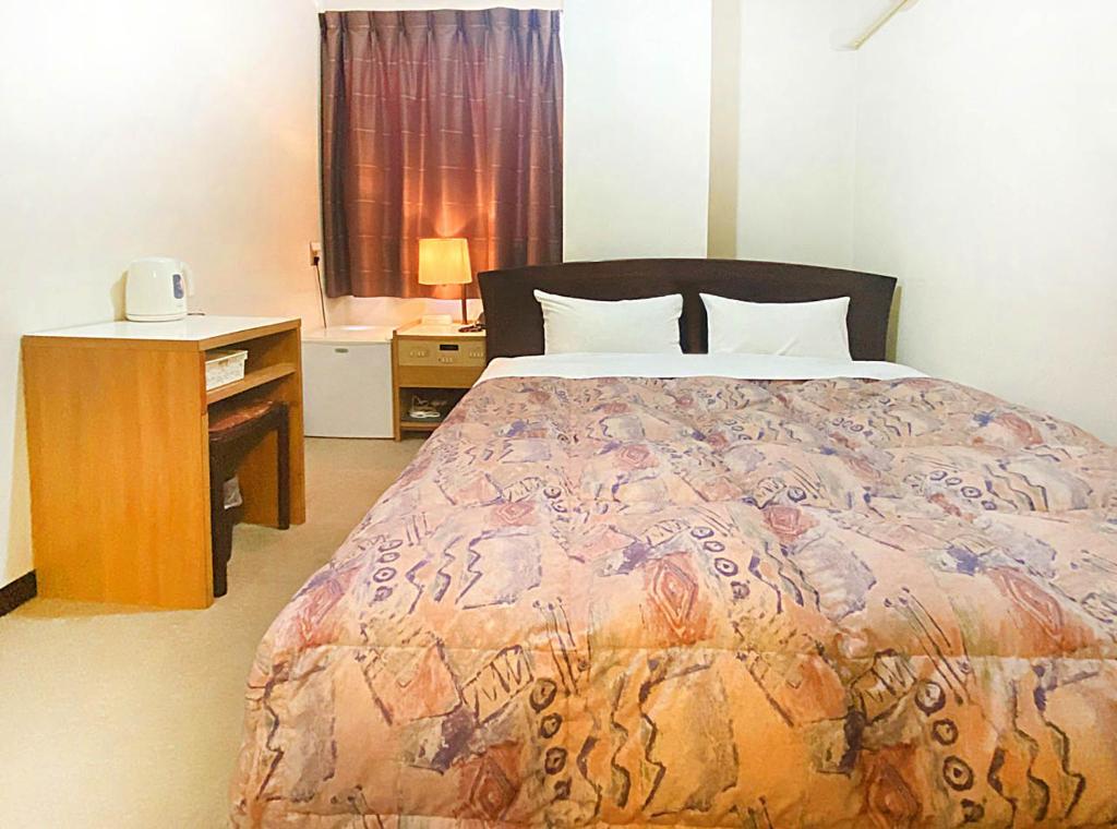 Postel nebo postele na pokoji v ubytování Hotel Okuni (Royal Inn Group)