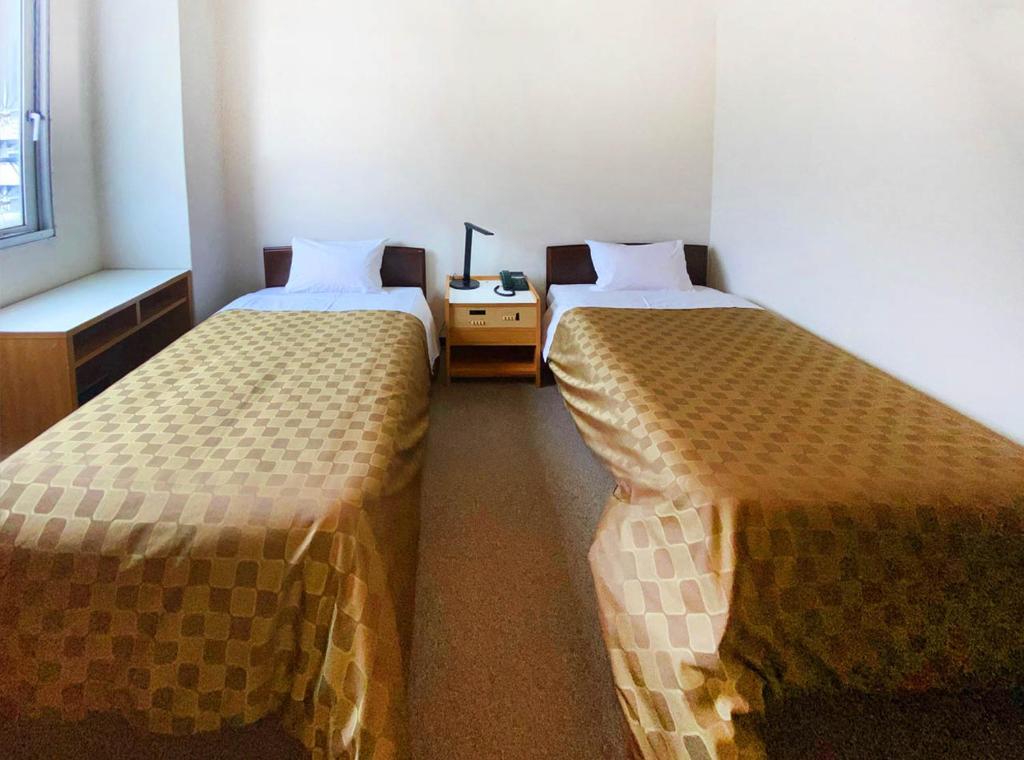 Postel nebo postele na pokoji v ubytování Hotel Okuni (Royal Inn Group)