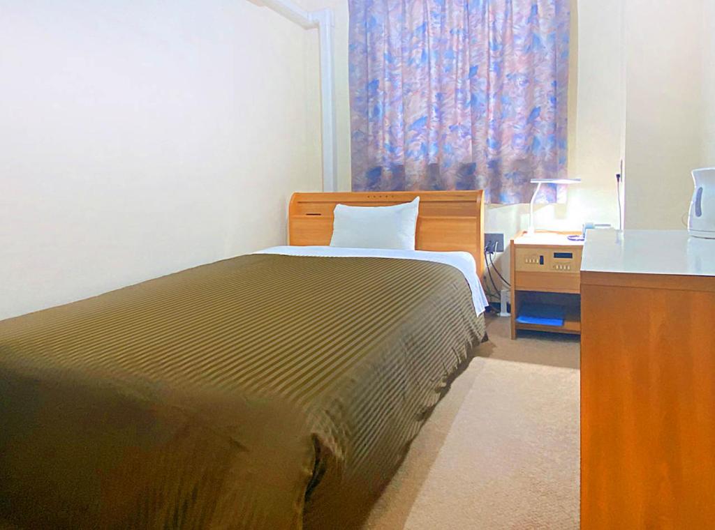 Postel nebo postele na pokoji v ubytování Hotel Okuni (Royal Inn Group)