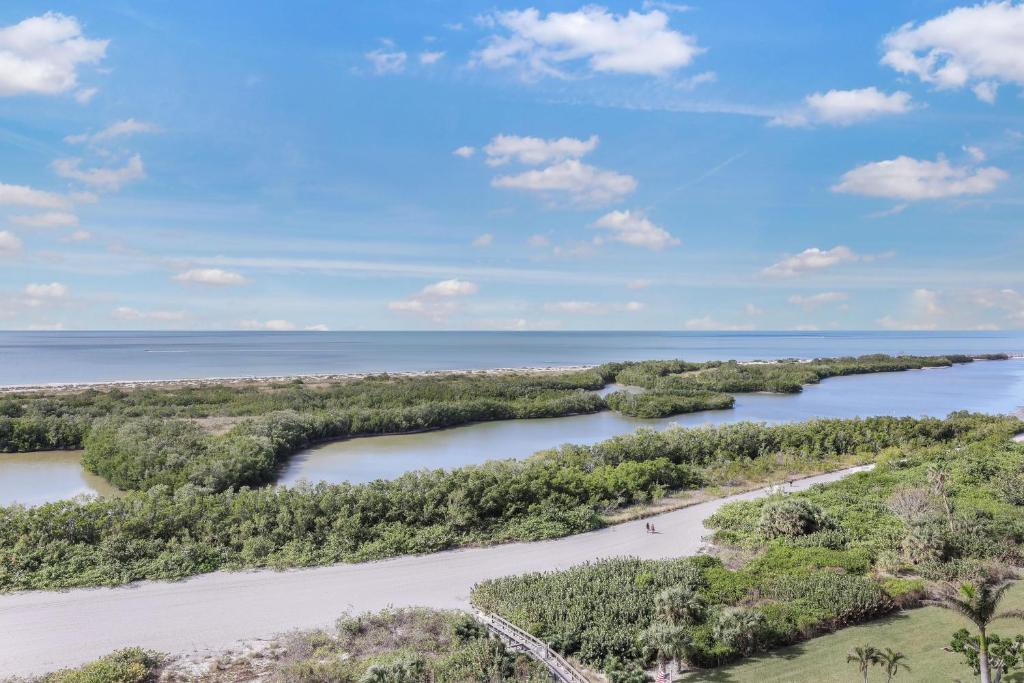 an aerial view of a river with trees and the ocean at Elegant beachfront condo in private community in Marco Island