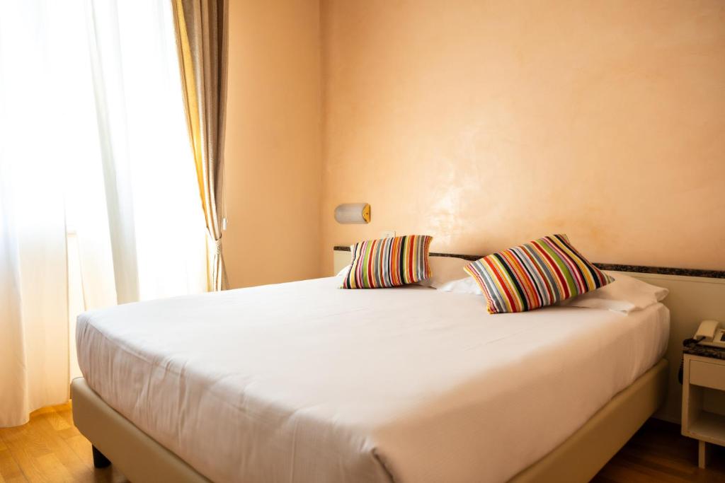 Postel nebo postele na pokoji v ubytování Hotel Rosabianca