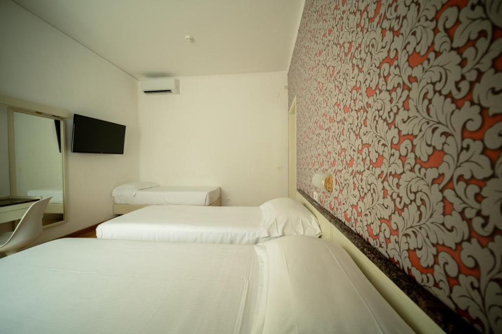 Postel nebo postele na pokoji v ubytování Hotel Rosabianca