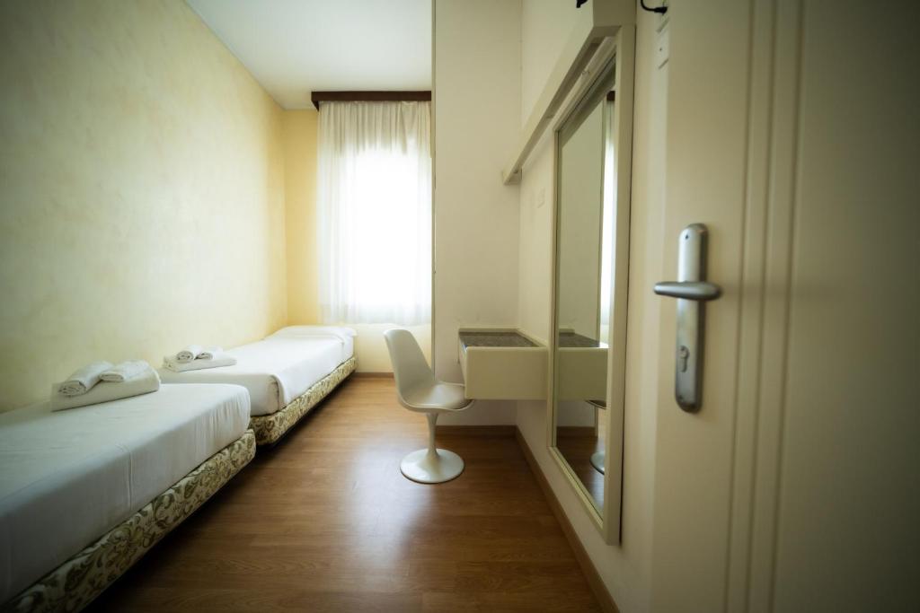 Postel nebo postele na pokoji v ubytování Hotel Rosabianca