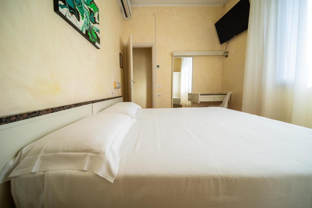Postel nebo postele na pokoji v ubytování Hotel Rosabianca