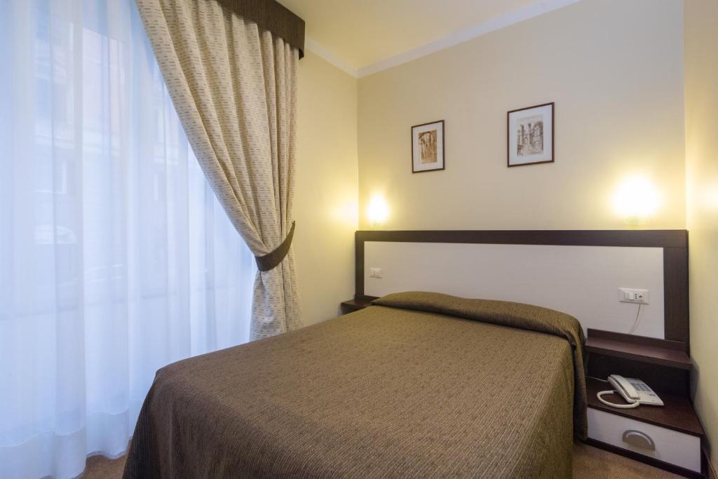 Кровать или кровати в номере Hotel Boccascena